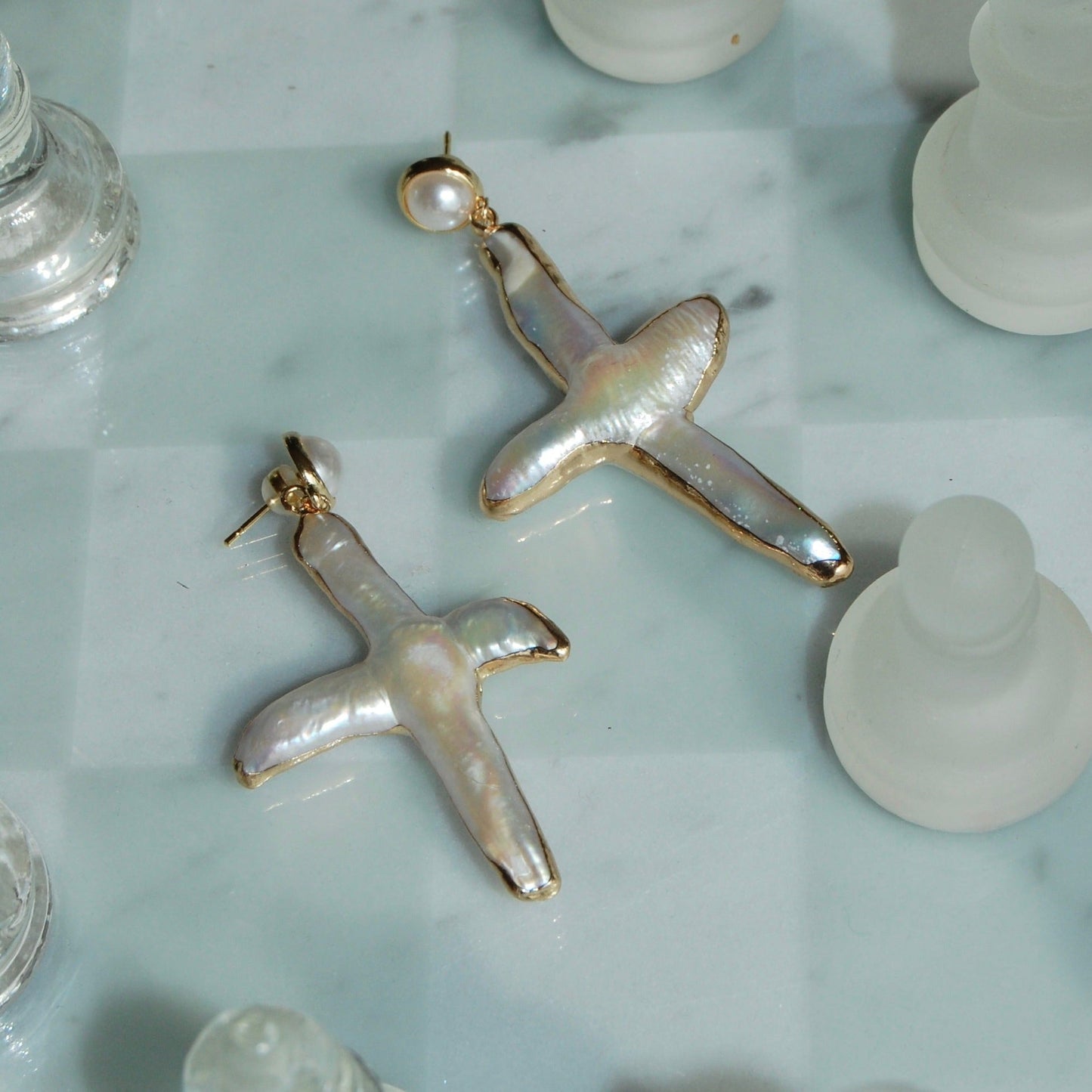 gold pearl cross earrings on pearl stud